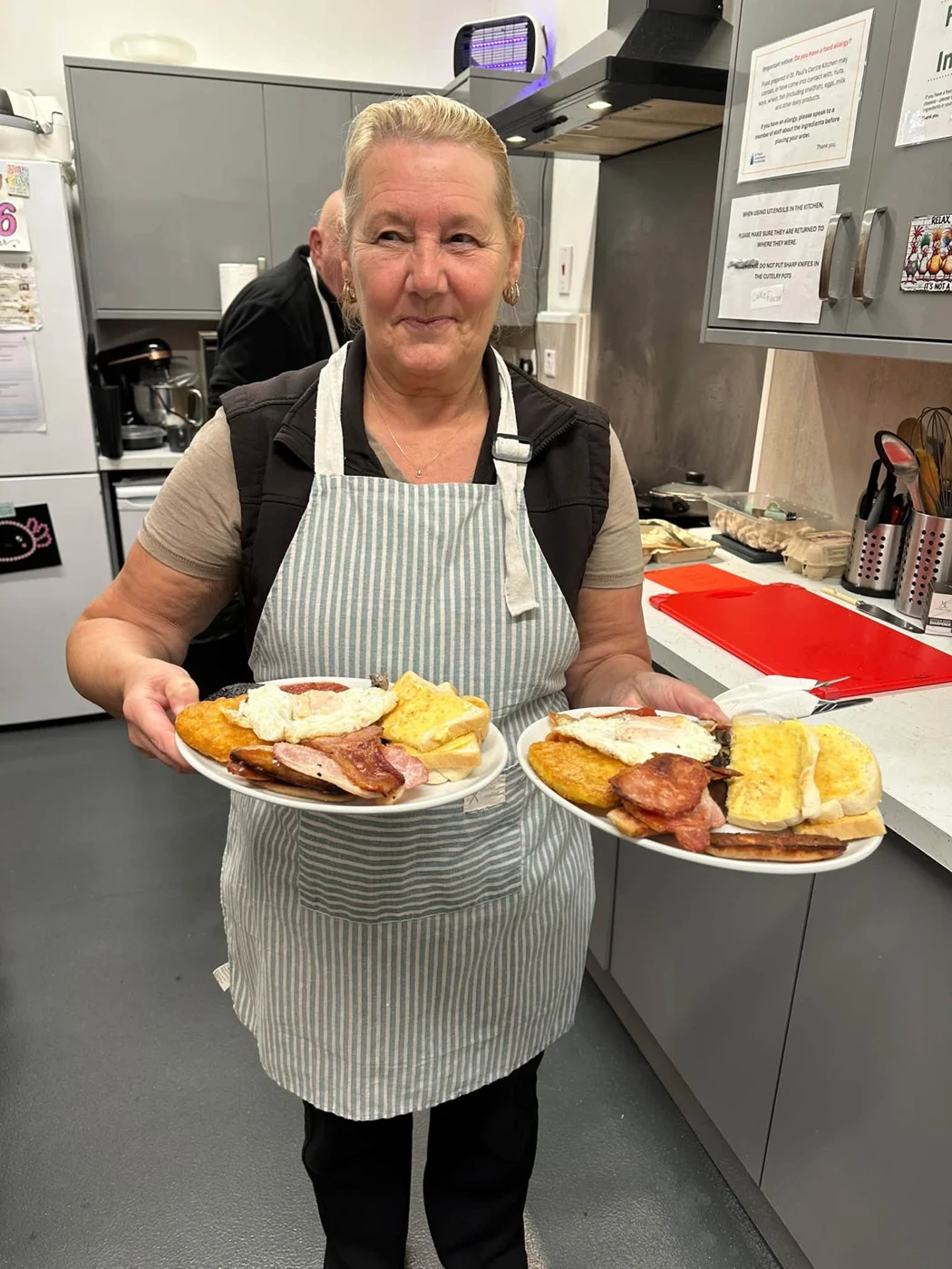 A member of the St Paul’s kitchen team serving two freshly cooked breakfasts