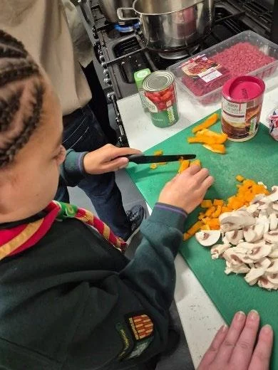 A child making colourful crafts at a table