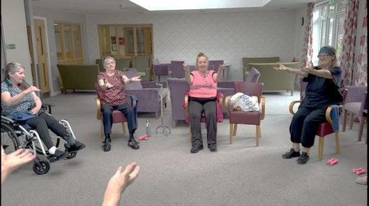 A group taking part in seated exercise